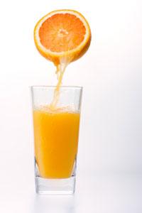 Orange Squeezing Juice into Glass